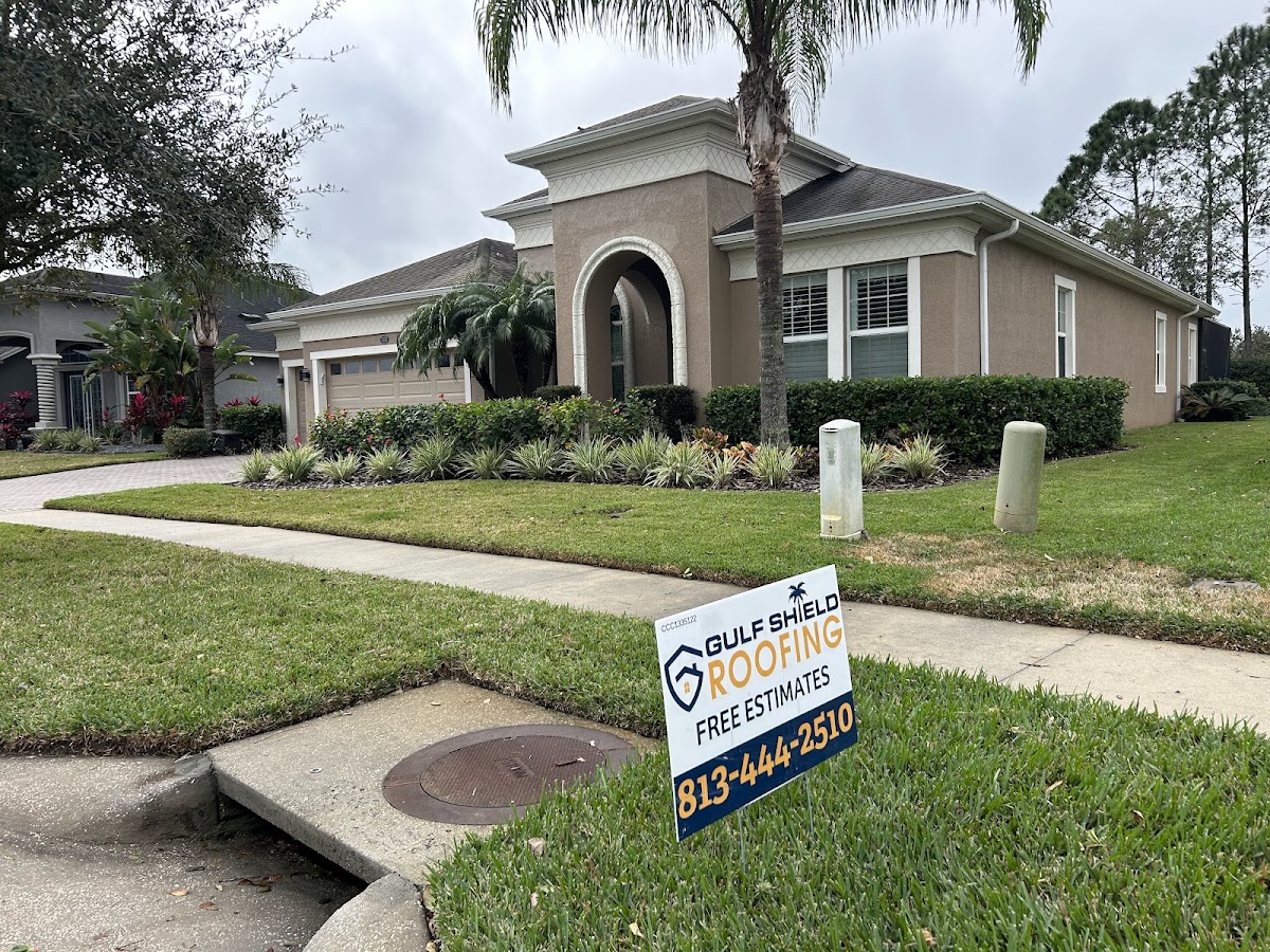 Residential exterior with a Gulf Shield Roofing yard sign